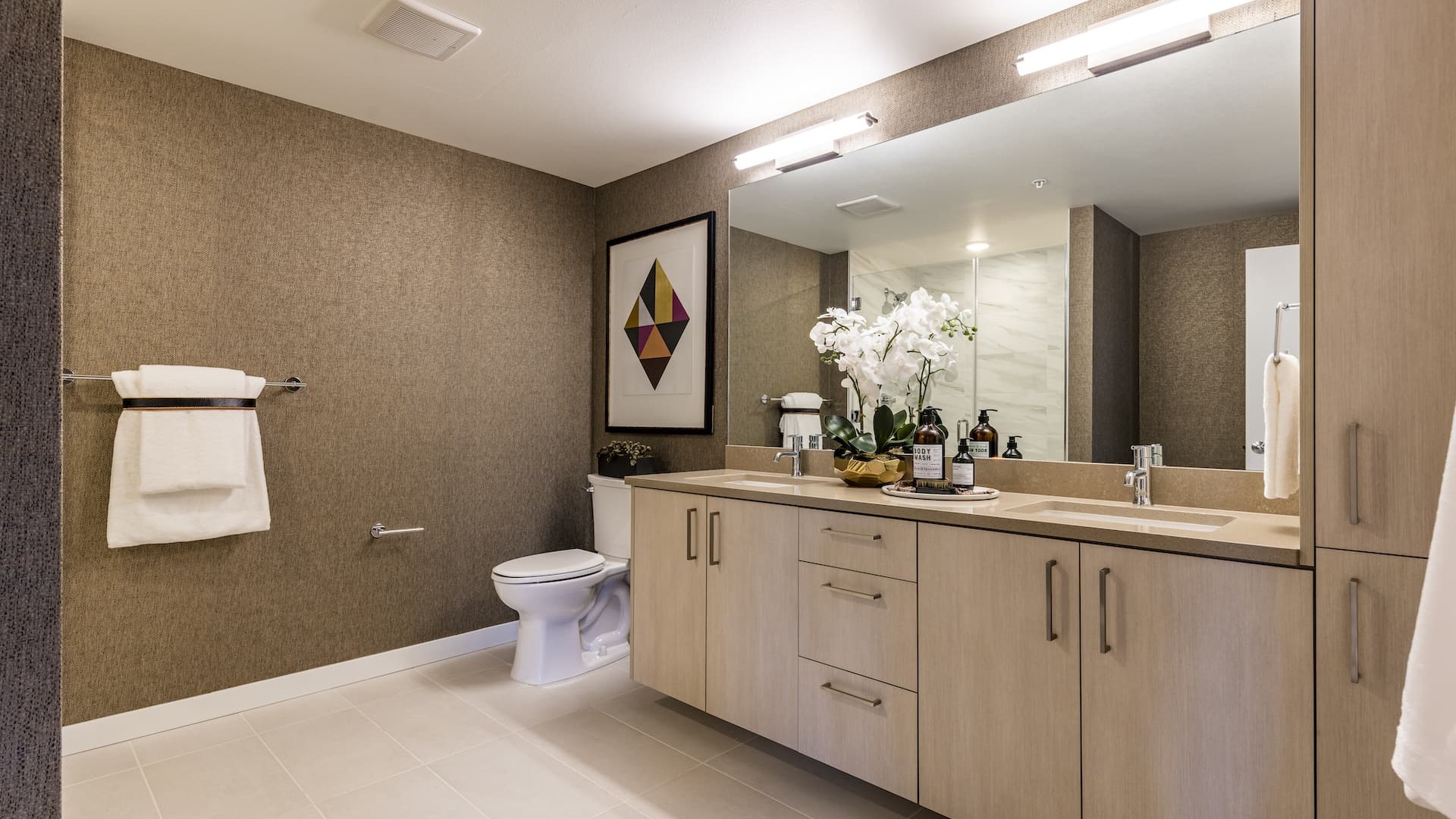 bathroom with dual sinks and ample counter-space